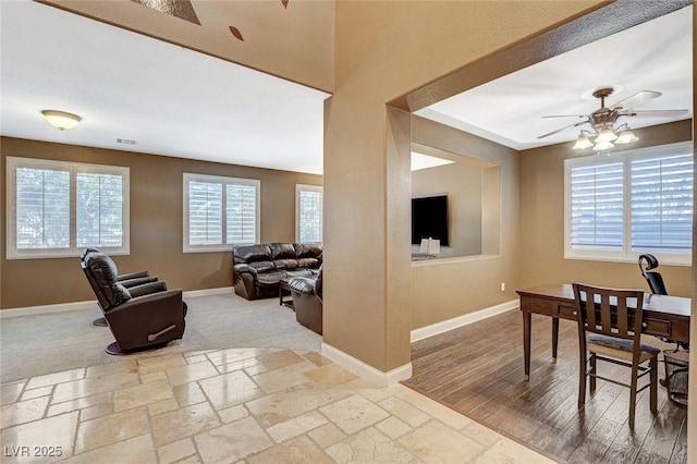 6409 Sea Swallow St, North Las Vegas, NV 89084 - dining area with ceiling fan, baseboards, and stone tile flooring