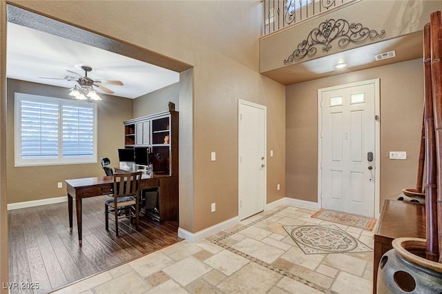6409 Sea Swallow St, North Las Vegas, NV 89084 - entryway with a ceiling fan, baseboards, and stone tile flooring