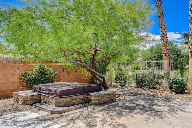 6409 Sea Swallow St, North Las Vegas, NV 89084 - view of patio with a covered hot tub and fence