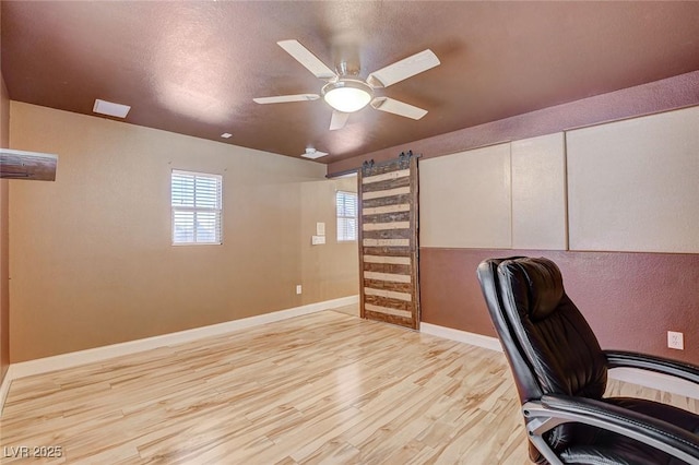 6409 Sea Swallow St, North Las Vegas, NV 89084 - unfurnished office with wood finished floors, healthy amount of natural light, baseboards, and ceiling fan