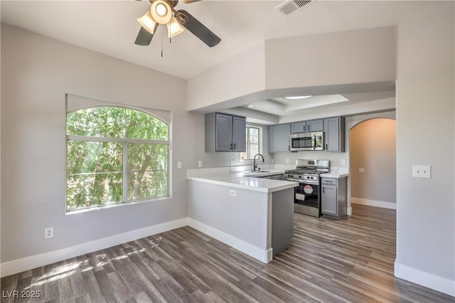 541 Indian Bluff St Unit 201, Las Vegas, NV 89145 - kitchen with stainless steel appliances, arched walkways, a sink, baseboards, and light countertops