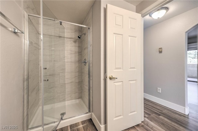 541 Indian Bluff St Unit 201, Las Vegas, NV 89145 - bathroom featuring a stall shower, baseboards, and wood finished floors