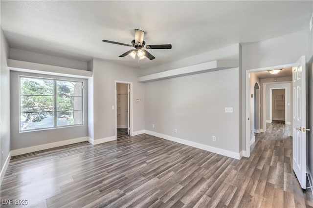 541 Indian Bluff St Unit 201, Las Vegas, NV 89145 - unfurnished bedroom with dark wood finished floors, baseboards, ceiling fan, and a closet