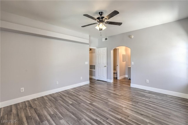 541 Indian Bluff St Unit 201, Las Vegas, NV 89145 - empty room featuring arched walkways, ceiling fan, wood finished floors, and baseboards