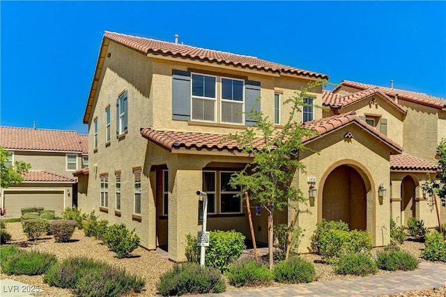 view of front of home featuring a tiled roof and stucco siding