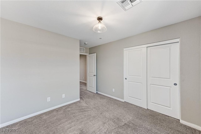 unfurnished bedroom featuring carpet, baseboards, and a closet