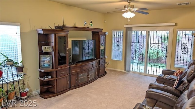 6339 Sharp Rock Ct, Las Vegas, NV 89139 - living area featuring light carpet, ceiling fan, healthy amount of natural light, and baseboards