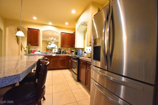 6339 Sharp Rock Ct, Las Vegas, NV 89139 - kitchen with appliances with stainless steel finishes, light tile patterned floors, decorative light fixtures, recessed lighting, and a chandelier