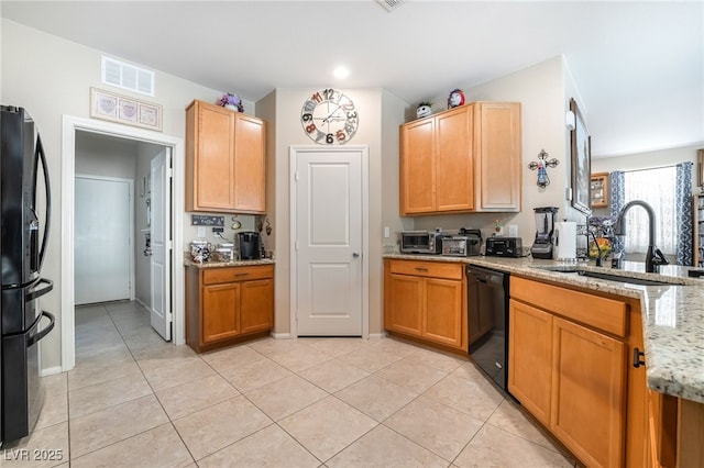 162 Sand Lake St, Henderson, NV 89074 - kitchen with black appliances, a sink, light stone counters, light tile patterned flooring, and a peninsula