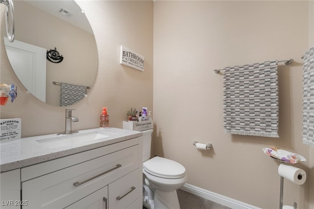 162 Sand Lake St, Henderson, NV 89074 - half bath featuring toilet, vanity, baseboards, and wood finished floors