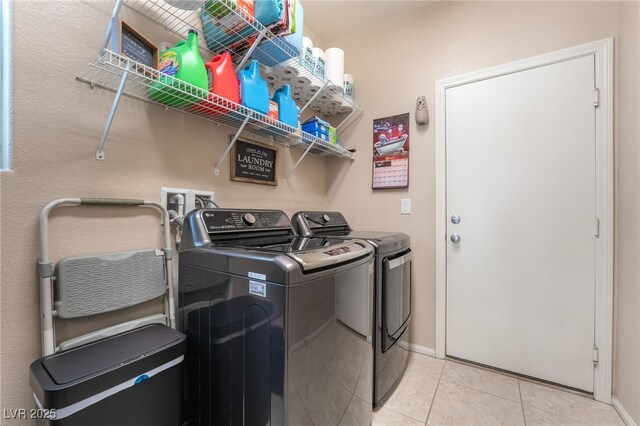 162 Sand Lake St, Henderson, NV 89074 - laundry area featuring washing machine and clothes dryer, light tile patterned floors, and baseboards