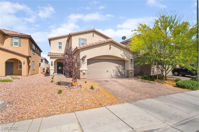 162 Sand Lake St, Henderson, NV 89074 - mediterranean / spanish house featuring driveway, stucco siding, a tiled roof, and a garage