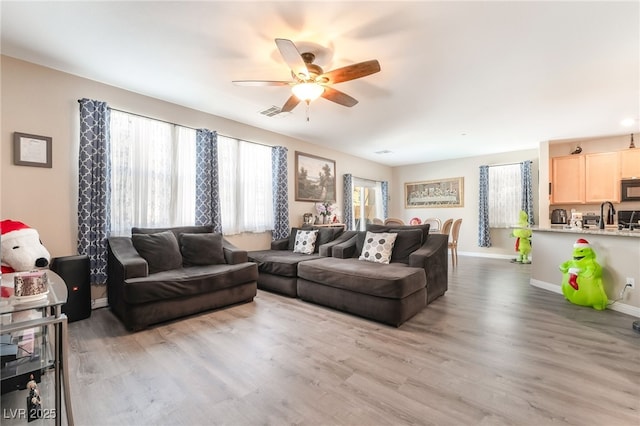 162 Sand Lake St, Henderson, NV 89074 - living room with a ceiling fan, wood finished floors, and baseboards