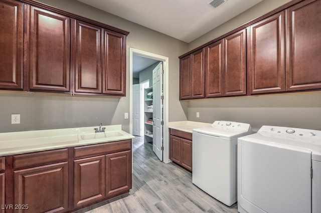 9760 Arch Canyon Ct, Las Vegas, NV 89149 - washroom with cabinet space, independent washer and dryer, and light wood-style flooring