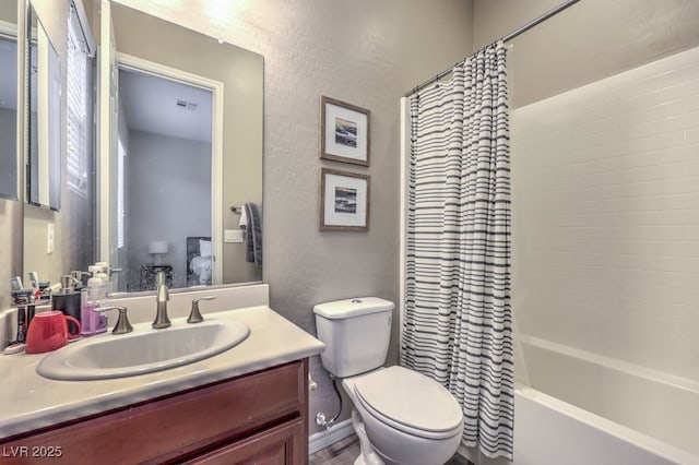 9760 Arch Canyon Ct, Las Vegas, NV 89149 - full bathroom featuring toilet, vanity, a textured wall, and shower / bath combo