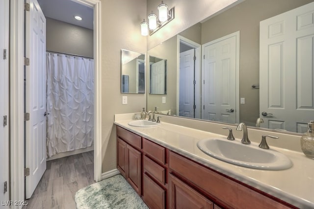 9760 Arch Canyon Ct, Las Vegas, NV 89149 - full bathroom with wood finished floors, double vanity, and a shower with shower curtain