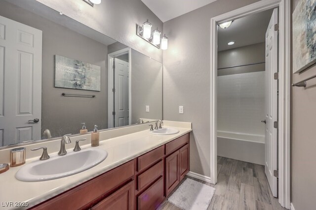 9760 Arch Canyon Ct, Las Vegas, NV 89149 - full bath featuring wood finished floors, double vanity, and washtub / shower combination