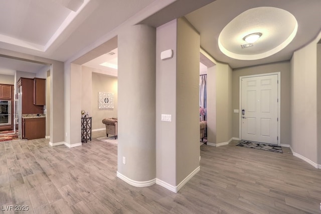9760 Arch Canyon Ct, Las Vegas, NV 89149 - foyer entrance featuring a tray ceiling, light wood finished floors, and baseboards