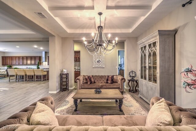 9760 Arch Canyon Ct, Las Vegas, NV 89149 - living room with a chandelier, wood finished floors, coffered ceiling, baseboards, and a raised ceiling
