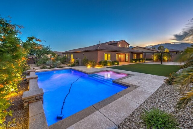 9760 Arch Canyon Ct, Las Vegas, NV 89149 - pool at dusk with a patio area, an outdoor pool, and an in-ground hot tub