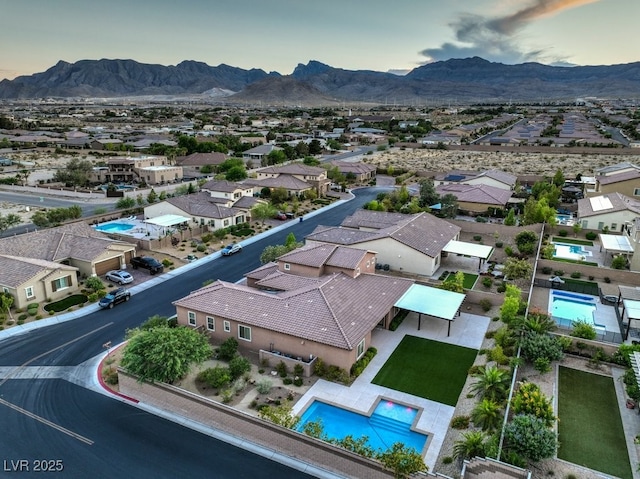 9760 Arch Canyon Ct, Las Vegas, NV 89149 - aerial perspective of suburban area with a pool and a mountainous background