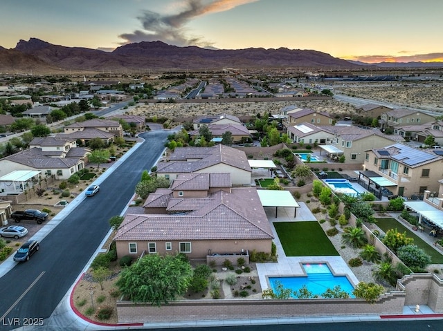 9760 Arch Canyon Ct, Las Vegas, NV 89149 - aerial view at dusk of a mountain view, view of pool, and a residential view