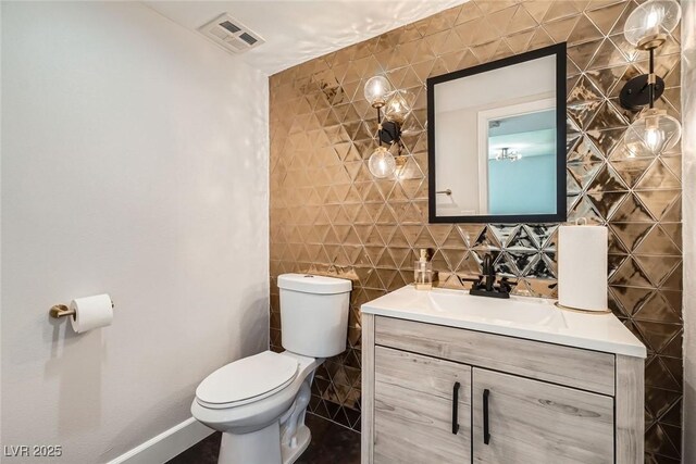 778 Vegas Valley Dr, Las Vegas, NV 89109 - half bath with toilet, tile walls, baseboards, and vanity