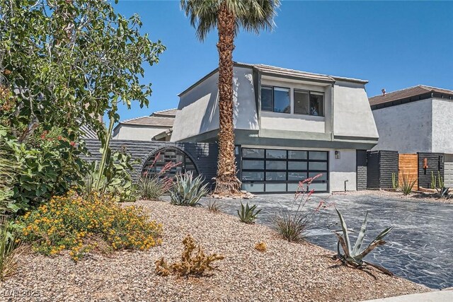 778 Vegas Valley Dr, Las Vegas, NV 89109 - view of front of property with an attached garage, driveway, stucco siding, and fence