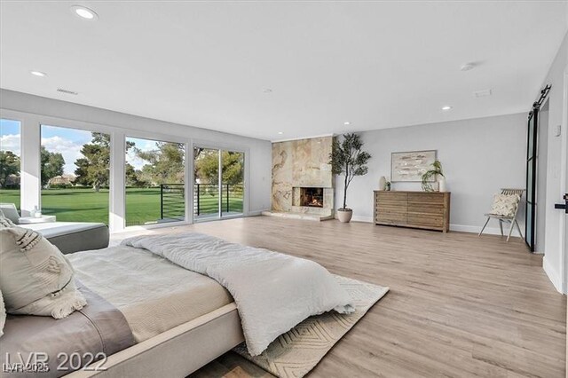 778 Vegas Valley Dr, Las Vegas, NV 89109 - bedroom with a premium fireplace, light wood-style flooring, recessed lighting, and baseboards