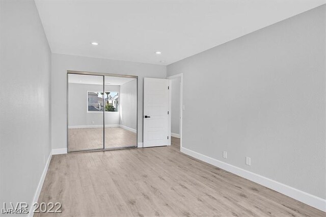 778 Vegas Valley Dr, Las Vegas, NV 89109 - unfurnished bedroom with wood finished floors, baseboards, a closet, and recessed lighting