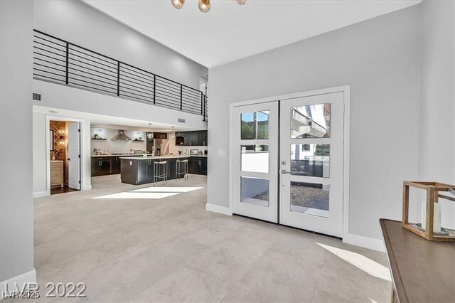 778 Vegas Valley Dr, Las Vegas, NV 89109 - doorway to outside with french doors, baseboards, a towering ceiling, and a chandelier