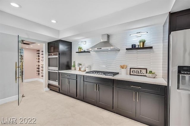 778 Vegas Valley Dr, Las Vegas, NV 89109 - kitchen featuring appliances with stainless steel finishes, wall chimney exhaust hood, open shelves, light countertops, and backsplash