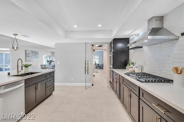778 Vegas Valley Dr, Las Vegas, NV 89109 - kitchen featuring stainless steel appliances, a sink, wall chimney range hood, light countertops, and recessed lighting