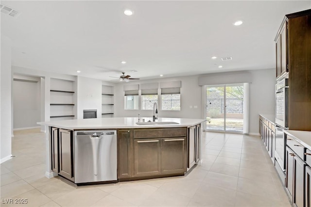 kitchen featuring a sink, stainless steel appliances, ceiling fan, light countertops, and recessed lighting