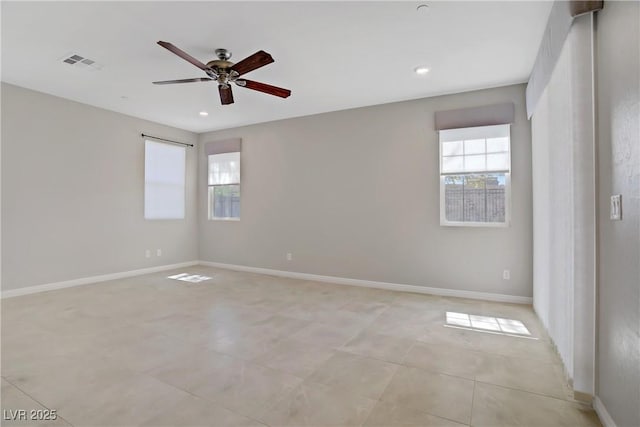 empty room with ceiling fan, recessed lighting, baseboards, and light tile patterned floors