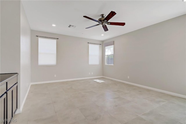 spare room with a ceiling fan, recessed lighting, and baseboards