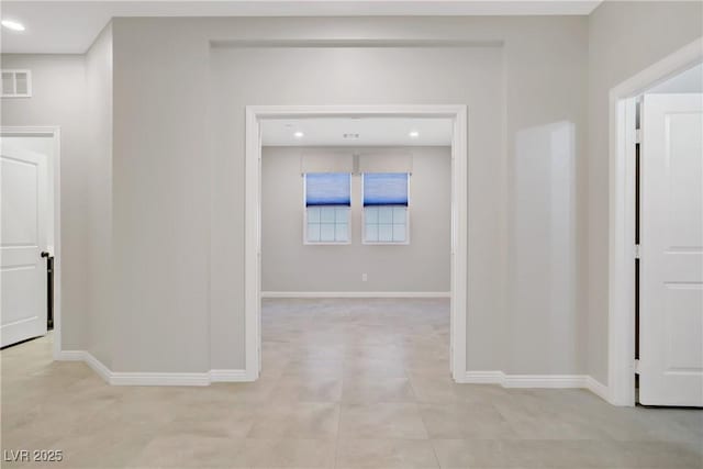 hallway featuring baseboards and recessed lighting
