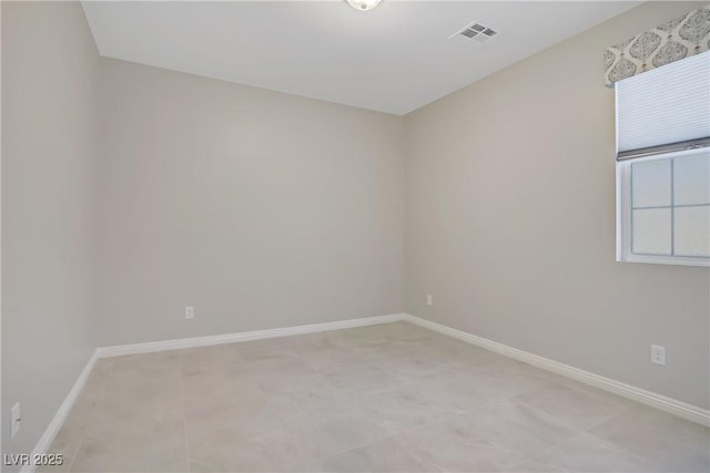 empty room featuring baseboards