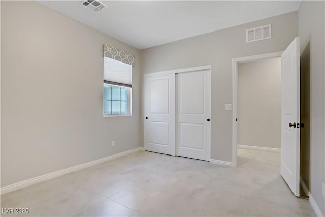 unfurnished bedroom with a closet and baseboards