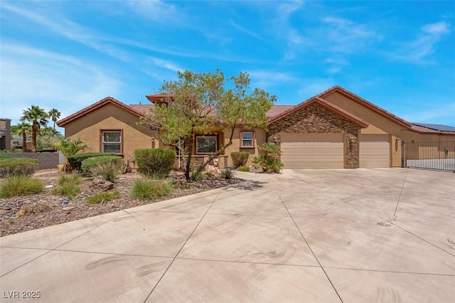 7668 Friendly Breeze Ct, Las Vegas, NV 89123 - view of front of property with driveway, a garage, stucco siding, a tile roof, and stone siding