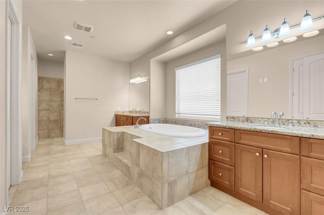 7668 Friendly Breeze Ct, Las Vegas, NV 89123 - bathroom with tile patterned floors, a garden tub, vanity, tiled shower, and recessed lighting