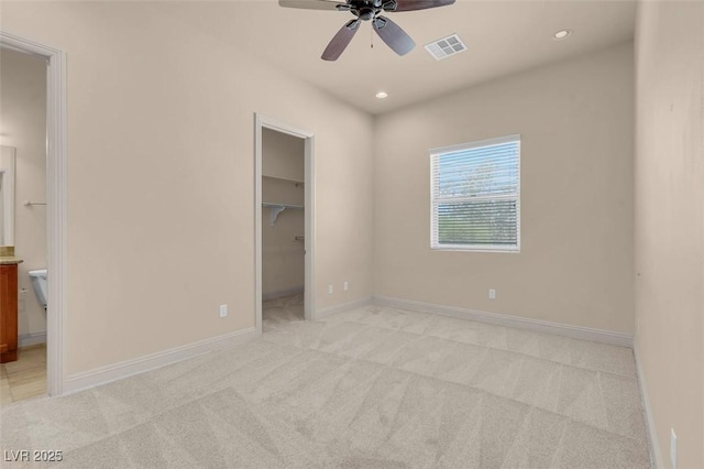 7668 Friendly Breeze Ct, Las Vegas, NV 89123 - unfurnished bedroom featuring a spacious closet, light carpet, recessed lighting, connected bathroom, and baseboards