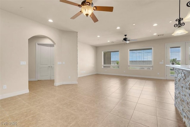 7668 Friendly Breeze Ct, Las Vegas, NV 89123 - unfurnished room featuring a ceiling fan, arched walkways, plenty of natural light, recessed lighting, and light tile patterned flooring