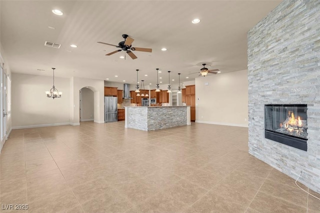7668 Friendly Breeze Ct, Las Vegas, NV 89123 - unfurnished living room featuring a ceiling fan, a stone fireplace, light tile patterned floors, and recessed lighting