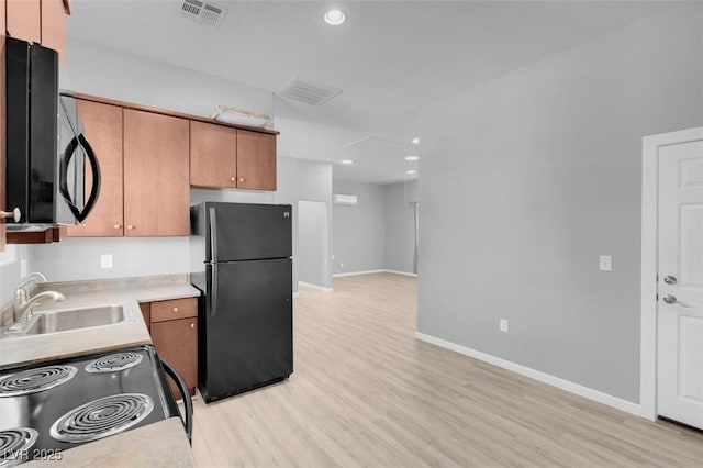7668 Friendly Breeze Ct, Las Vegas, NV 89123 - kitchen with black appliances, a sink, light wood finished floors, light countertops, and recessed lighting