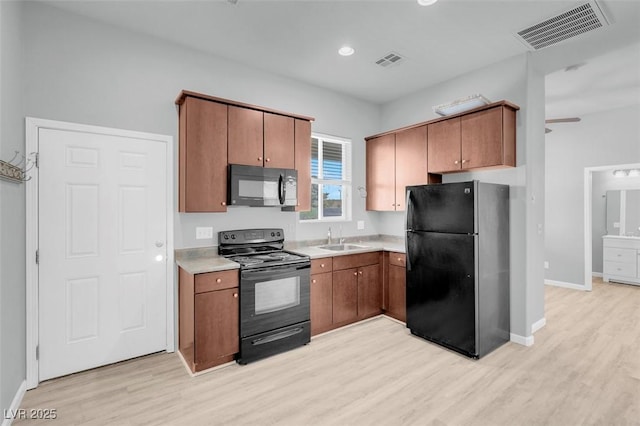 7668 Friendly Breeze Ct, Las Vegas, NV 89123 - kitchen featuring black appliances, a sink, light wood-type flooring, light countertops, and recessed lighting