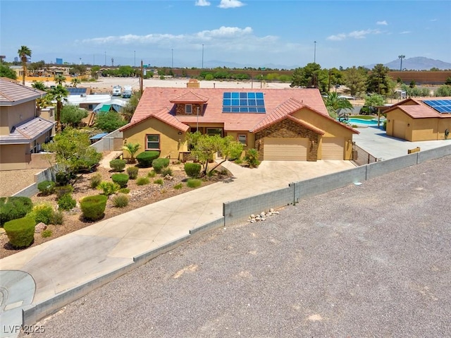 7668 Friendly Breeze Ct, Las Vegas, NV 89123 - view of front of home with solar panels, a tiled roof, fence, driveway, and an attached garage