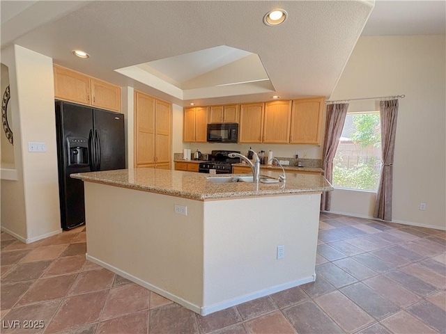 1564 Silver Knoll Ave, Las Vegas, NV 89123 - kitchen featuring black appliances, a sink, baseboards, light stone countertops, and a center island with sink