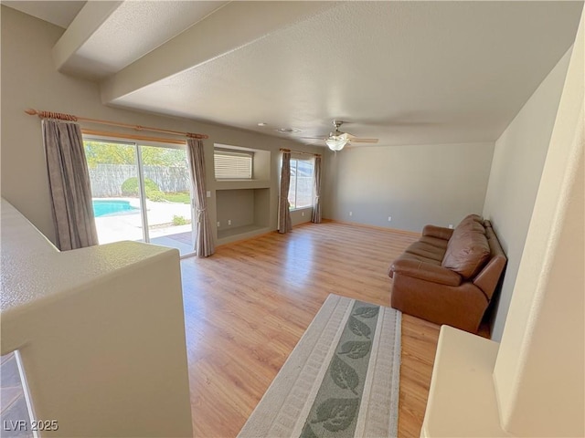 1564 Silver Knoll Ave, Las Vegas, NV 89123 - living room featuring healthy amount of natural light, light wood-style flooring, ceiling fan, and baseboards