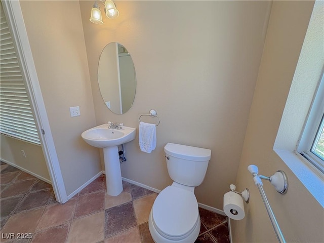 1564 Silver Knoll Ave, Las Vegas, NV 89123 - bathroom featuring toilet, baseboards, and a sink
